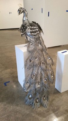 asylum-art-2:  Metal Peacock   Made Of Spoons And Other Metal Things Found At Home  More: reddit.com  Peacocks aren’t terribly metal, but this  university student made one worthy of a rock album cover. What’s more,  she used only found metal and