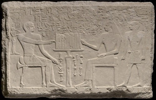 Stele of Thenti and NefertThis fragment portrays the judge and scribe Thenti sitting opposite his wi