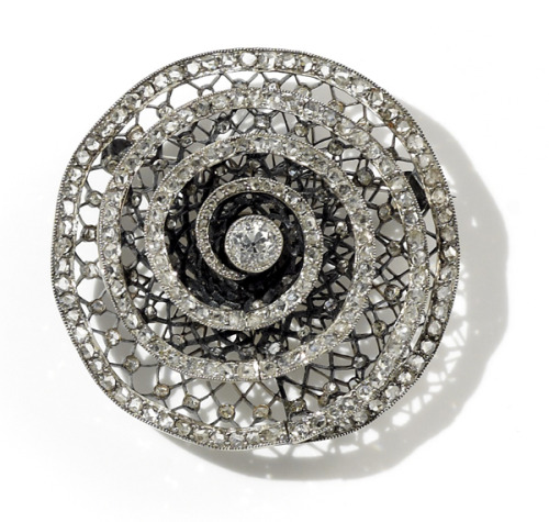 An antique diamond brooch attributed to Coulon,in the form of a stylised rose, set with swirling ros