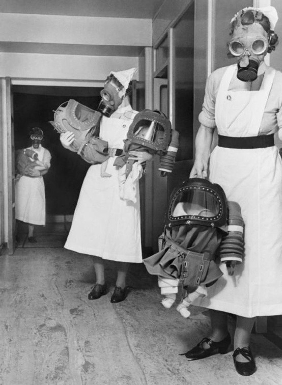 sacrificeherbody:  1940 - Three nurses carry babies cocooned in baby gas respirators