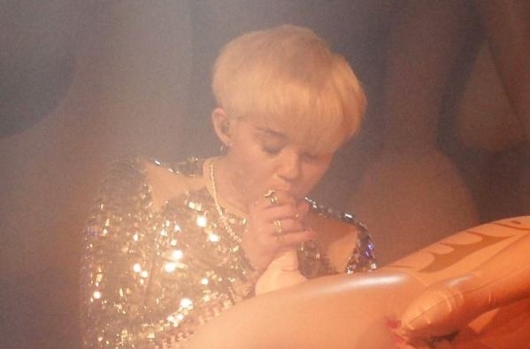 Miley Cyrus blowing a doll. More please!