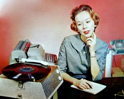 theniftyfifties:  An office record party for one. 