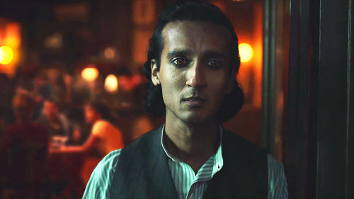 Armand standing at the door of the café watching Santiago come to abduct Louis, Claudia, and Madeleine.