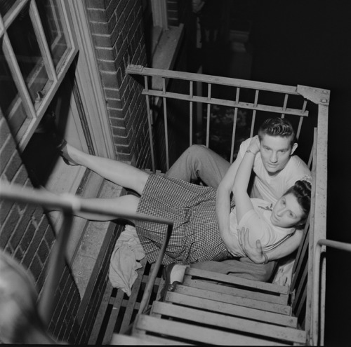 vintageeveryday: Couple flirting on a fire escape, 1946. Photographed by Stanley Kubrick.