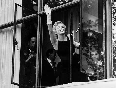 Marilyn Monroe Waving to fans outside the Savoy Hotel, London. 1956