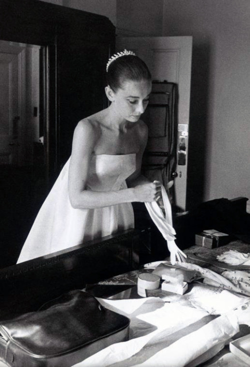 mrsclarkkent: rubybyann Audrey Hepburn, at a dress fitting, chooses a pair of gloves to match her Gi