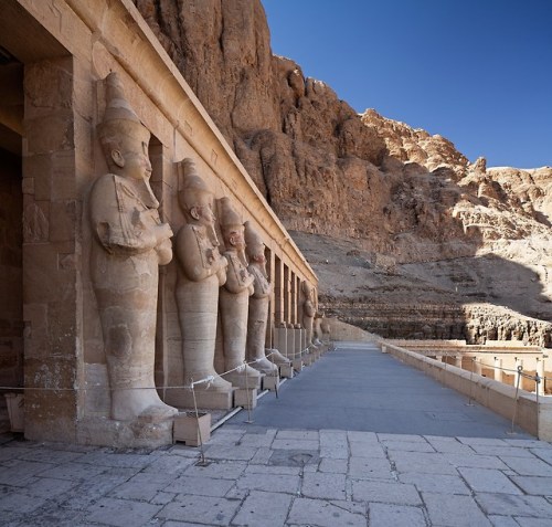 Colossal Osiride statues of the queen Hatshepsut at the entrance causeway of her temple.
