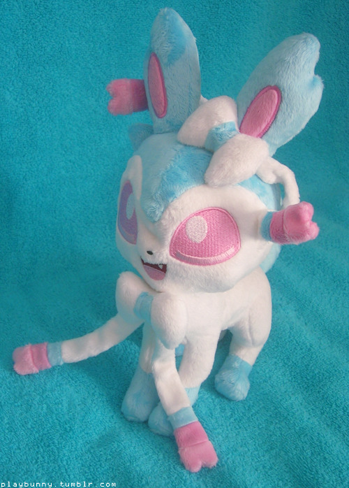 I am legit screaming everywhere right now !! Look at what I got today !! This is a shiny Sylveon plush I commissioned the lovely spacevoyager for of my in game, shiny female Sylveon, Charlie.  She’s absolutely perfect and stands up well on her