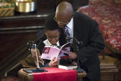 yungmicro:  thepoliticalnotebook:  Brown Baptist Memorial Church, Brooklyn. Akai Gurley’s little brother Malachi Palmer is comforted by his stepfather as he reads at Gurley’s funeral today. An unarmed Gurley was killed in November by the NYPD.  Photo