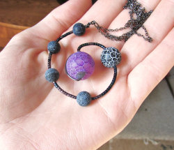 wickedclothes:  Moons Of Pluto Necklace Pluto, while not recognized definitively as a planet, is often referred to as a dwarf planet by some. Others think that Pluto is simply a ball of ice and dirt, or perhaps an asteroid. Regardless of its definition,