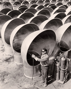 natgeofound:  A welder works on cowls for