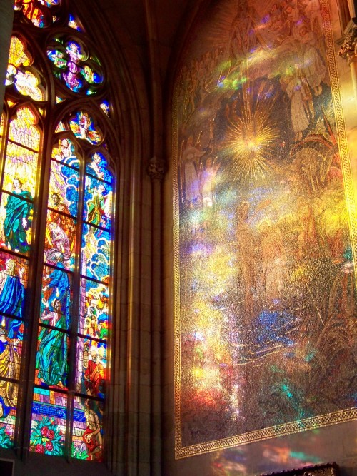 glitzandgrandeur: Light reflecting through a stained glass window onto a wall mosaic.  Photogra