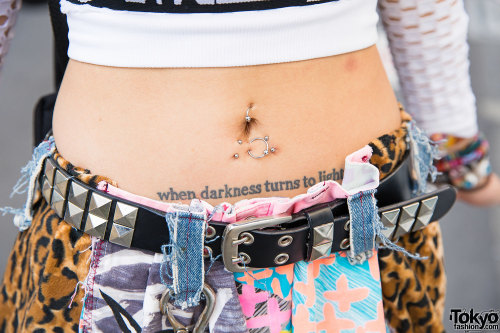 Pierced and tattooed Momoko on the street in Harajuku wearing a DVMVGE top, Nanananoka shorts, YRU p