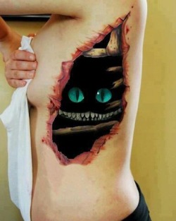 piercingsandink:  the-toxic-mermaid:  Probably one of the best tattoos of the Cheshire Cat so far (:  that’s not a tattoo, someone has edited the cheshire face into the original photo of a rib tattoo… 