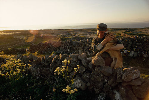 natgeofound: A farmer embraces his dog in his stonewalled field on Inishmore Island in Ireland, Marc