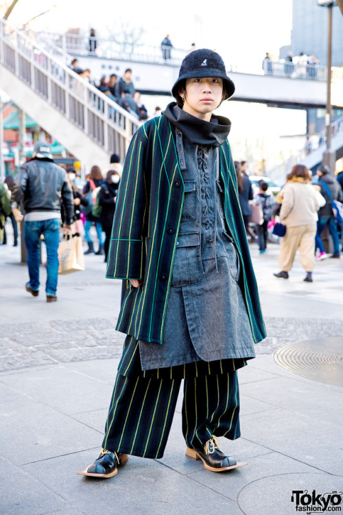 19-year-old Naoya on the street in Harajuku wearing a striped outfit by the Japanese streetwear bran