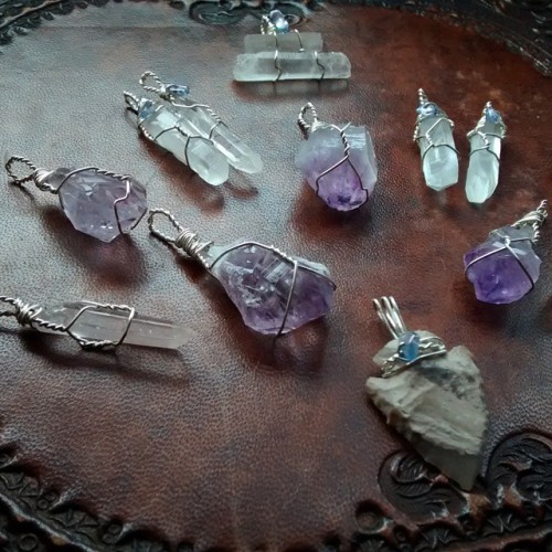wire wrapped clear quartz, raw amethyst pendants and one agate arrowhead with tanzanite beads. wish 