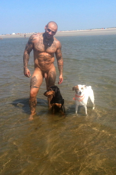 guyzbeach:More on guyzbeach, a collection of natural men naked at the beach !  Love it . a hot man and his cute dogs