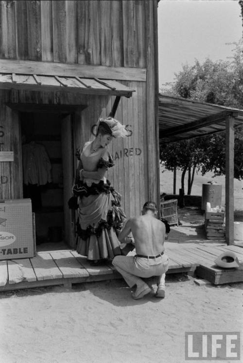 Repairing Miss Kitty’s wardrobe(Allan Grant. 1957?)