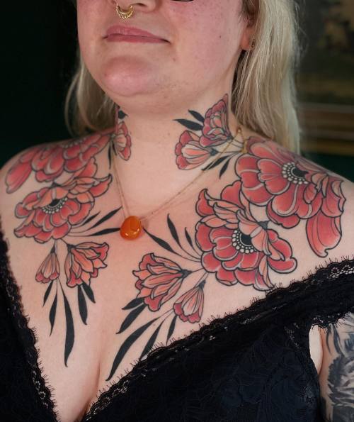 allthepiercingsandbodymods:Flower chest and neck tattoos by Jentonic.