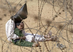 kitaab-e-dil: a-delicatesoul:  schrodinger-is-in-the-box:  Iraq, 2003. An Iraqi prisoner of war tries to calm down his son.  One of my favorite pictures on tumblr.  An Iraqi prisoner of war tries to calm his son… I wonder how he willed his own hands
