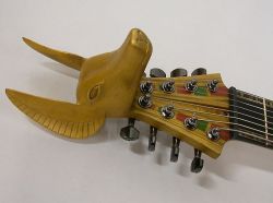amplifiedparts:  Finnish guitar maker Amfisound does some seriously amazing craft work. The detail in this Egyptian 8-String Explorer styled guitar is phenomenal! I love that head stock and the detailed inlays in the neck.  http://www.amplifiedparts.com
