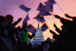 gettyimages:  Barack Obama Sworn In As U.S. President For A Second Term People wave American flags as people gather near the U.S. Capitol building on the National Mall for the Inauguration ceremony on January 21, 2013 in Washington, DC. U.S. President