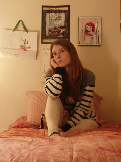 In the bedroom in white textured wool tights and striped sweater