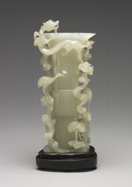 Jade Gu-shaped vase with dragon-in-the-cloud and divine-crane motif. Mid Qing Dynasty, 1736-1820 AD