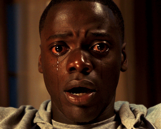 A GIF of a young Black man staring ahead in shock while a tear rolls down his face.