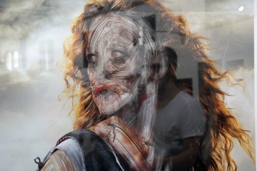 sixpenceee:Berlin street artist, Vermibus dissolves advertisements with solvents, giving them an eerie mummified look. Watch his video here: X More posts like this here: X