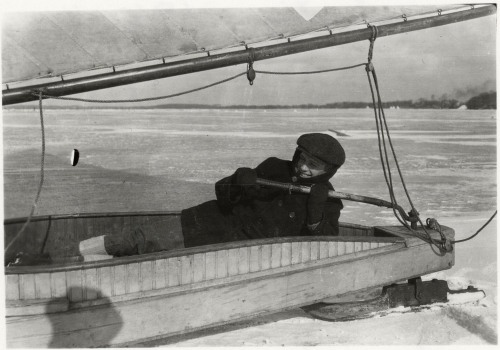 Iceboating, a man  identified as &ldquo;Grede&rdquo; lays in an iceboat on Lake Mendota