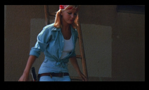 Today’s B-movie babe is looking stunning in a double denim ensemble accessorized with a trendy “Wome