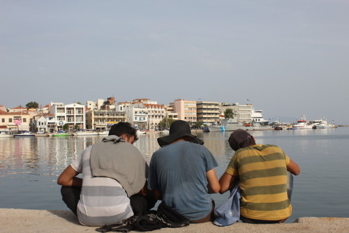 Immigrants resting on the port of Lesvos Island.