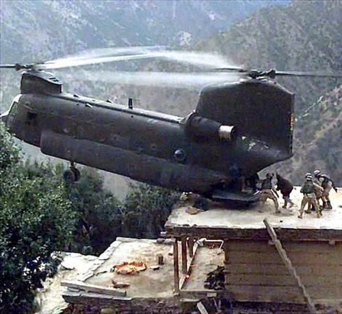 U.S. Army CH-47D Chinook, performs a pinnacle landing on the roof of a house in Afghanistan to pick 