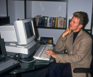 leadmaster:  David Bowie working with an early model of an Apple computer. 