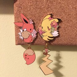 retrogamingblog:  Pikachu and Eevee dangling tail pins made by Toasterkiwi