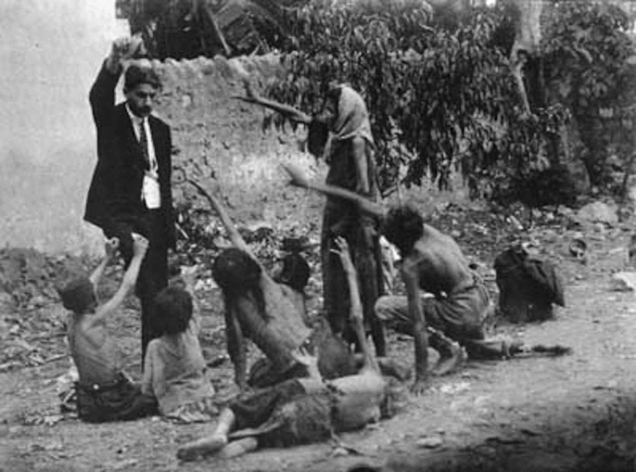 Turkish official teasing starved Armenian children by showing bread during the Armenian