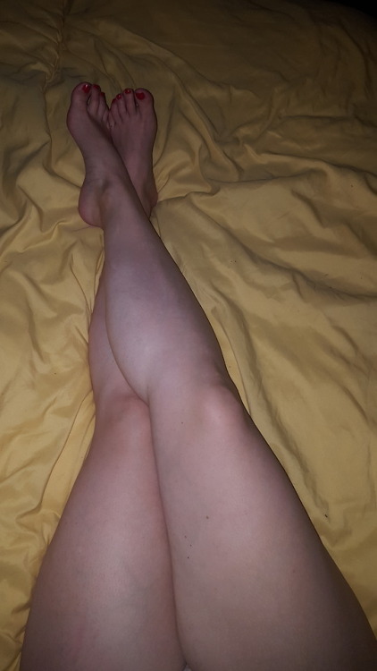 My pretty wifes sexy legs and feet laying in bed.please comment
