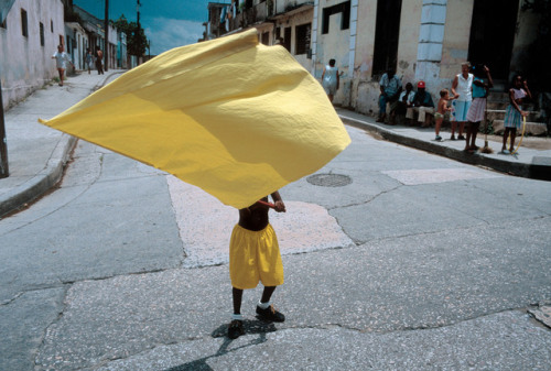 unearthedviews: CUBA. Santiago de Cuba. 1998. A young boy carrying a yellow banner during carnival. 