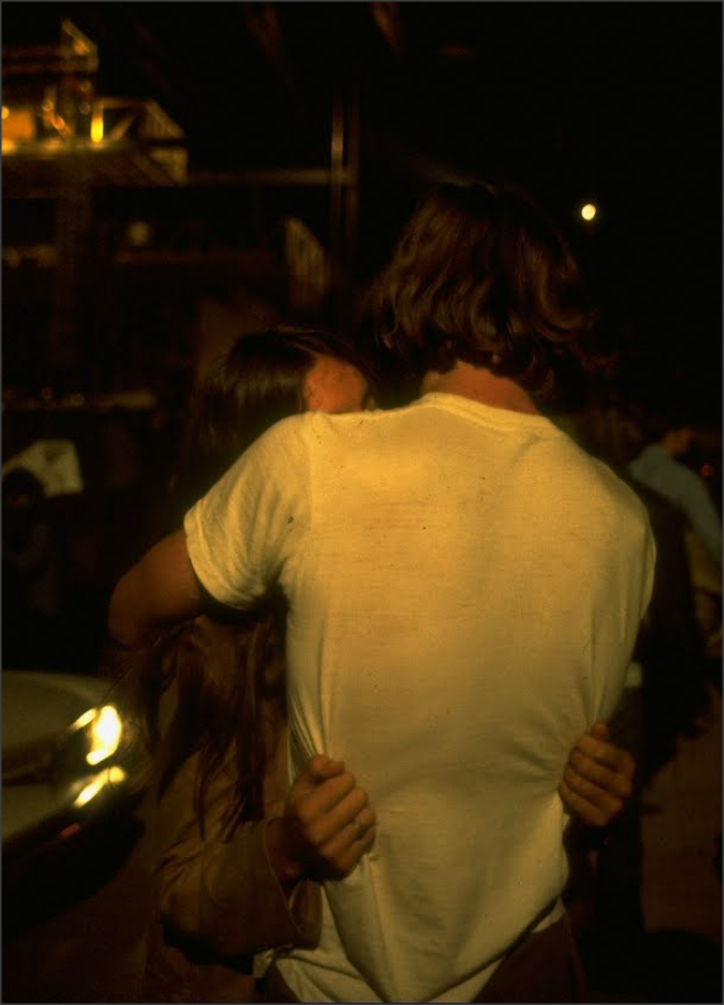 1950sunlimited:Young Couple seen from the back kissing at night at Woodstock, 1969Bethel,
