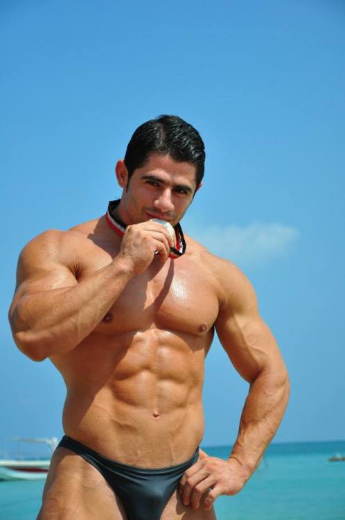 muscleclubeblogger:  Sergio Miguelez: medal munching at the seaside with well shaped outline in his black posers