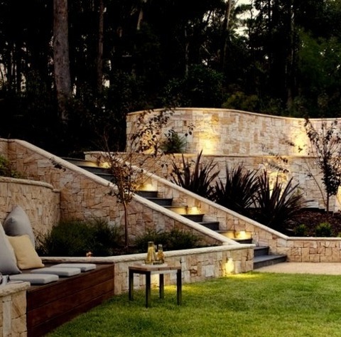 Photo Of A Large Contemporary Backyard Stone Retaining Wall Landscape.