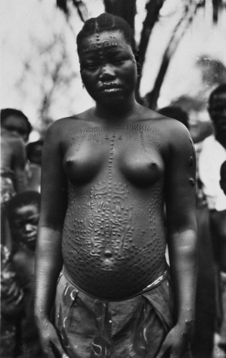 congo-mondele:  A young woman with scarifications on the face and upper body. 1929-1937.