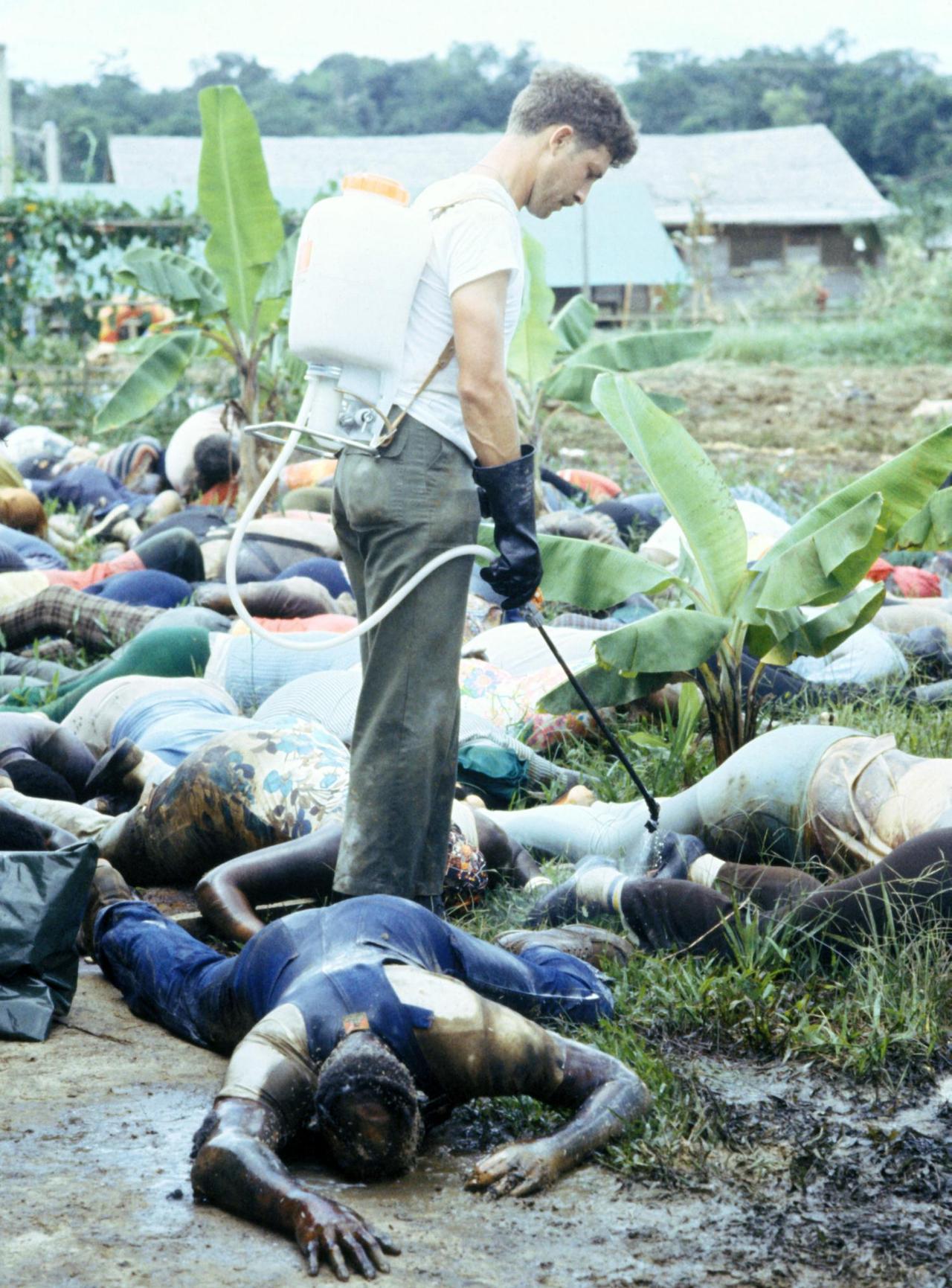 historicaltimes: A US Army officer sprays disinfectant over the bodies of the Jonestown