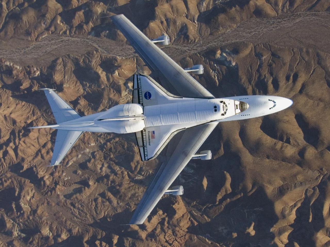 “Space shuttle Discovery is lowered onto the Shuttle Carrier Aircraft in the mate-demate