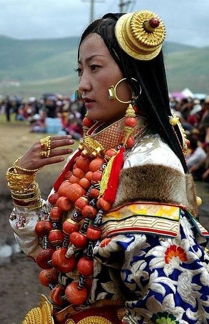 Khampa people, Tibet (Click to enlarge) The large orange-red beads are coral. These huge coral neckl