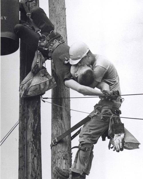 historicaltimes:“The Kiss of Life”: A utility worker, J.D. Thompson, giving mouth-to-mouth to co-worker Randall G. Champion after he contacted a high voltage wire -Full details in comments- cobb__salad: This photo shows two power linemen,