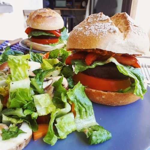 Vegan burgers Cross and soft burger buns topped with avocado, lemon juice tomato quinoa spread, sala