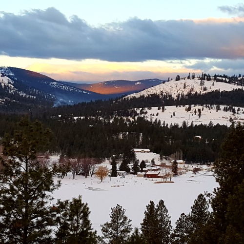 Sunrise glow lights up distant mountains.